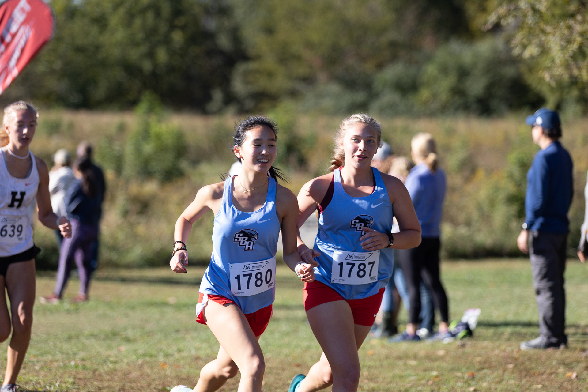 Sommer Griffis and Sarah Wiggins turn the corner in the region meet. (Photo by Ryan Beatty)